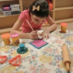 Dr. Thornburg's Granddaughter Making Tiles